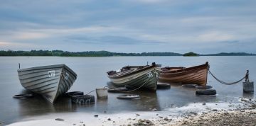 Three Row Boats on an Irish Lake. Photo by Daniel Kane Photography.