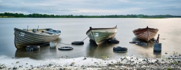 Three Boats on a Still Lake. Photo by Daniel Kane Photography.